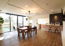 A spacious dining space and a kitchen in the back.